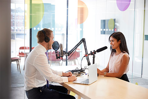 man and woman talking in a studio